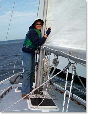 Photo of Capt Kathy Sheehan  kissing the sails of her boat