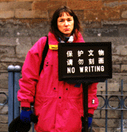 Photo of Kathy Sheehan -- sad because she is in front of a `No Writing` sign.
